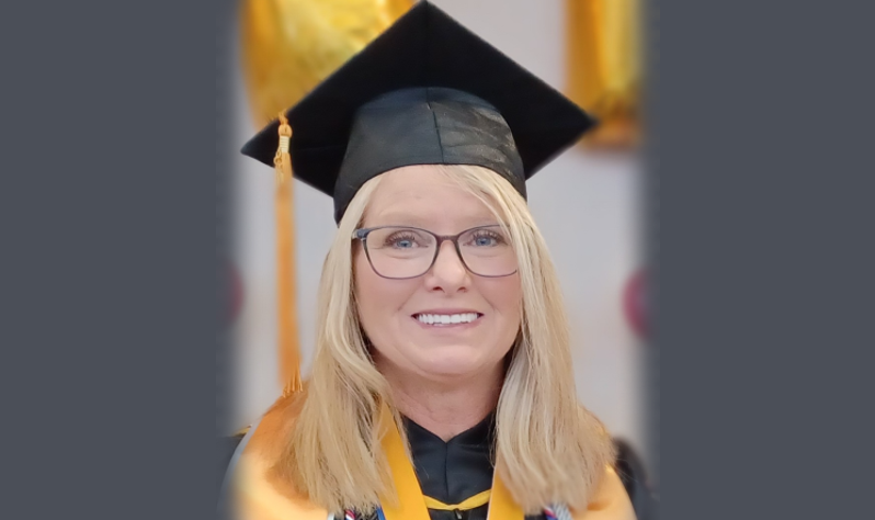 A headshot of Kelly Pilotte in graduation cap and gown